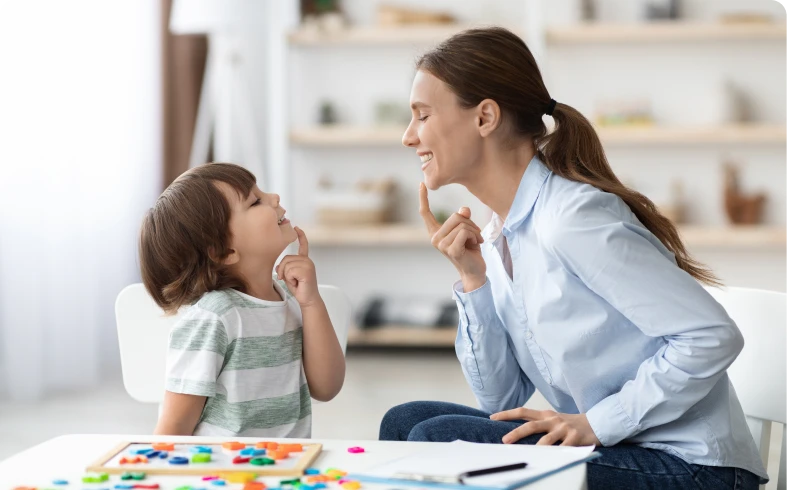 Smiling woman teaching child at home