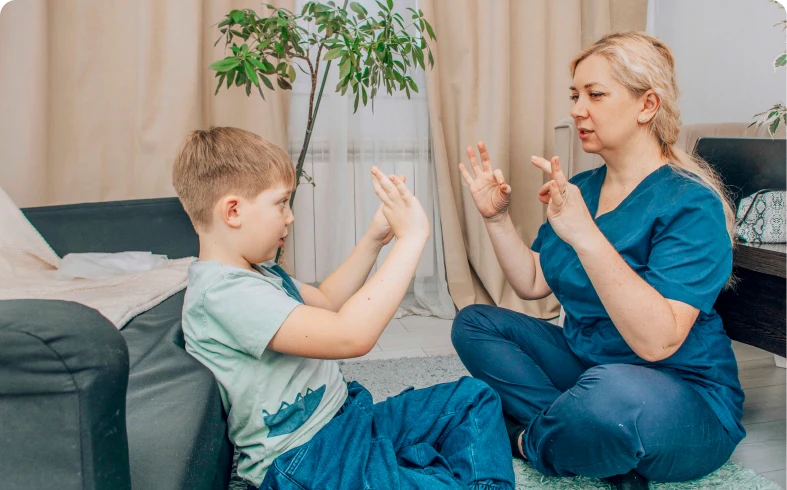 Boy learning sign language with teacher