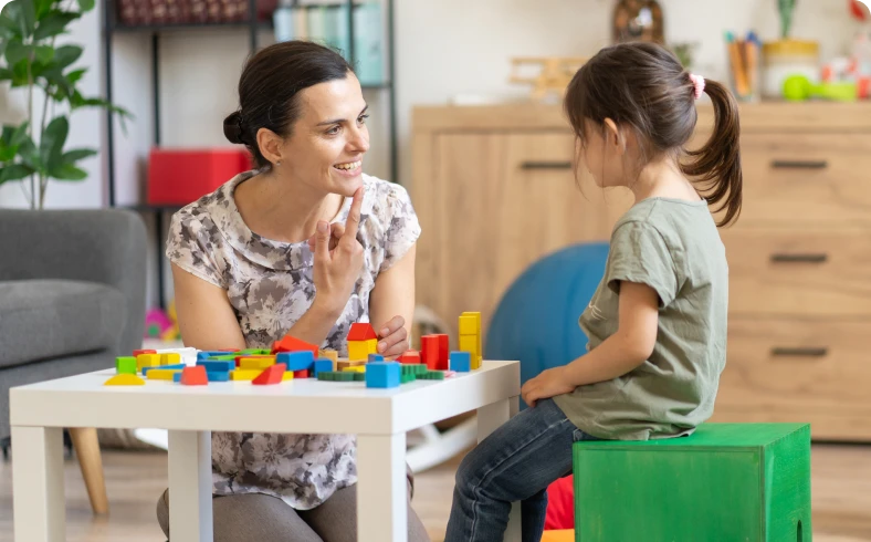 Teacher and child engaging in learning activity