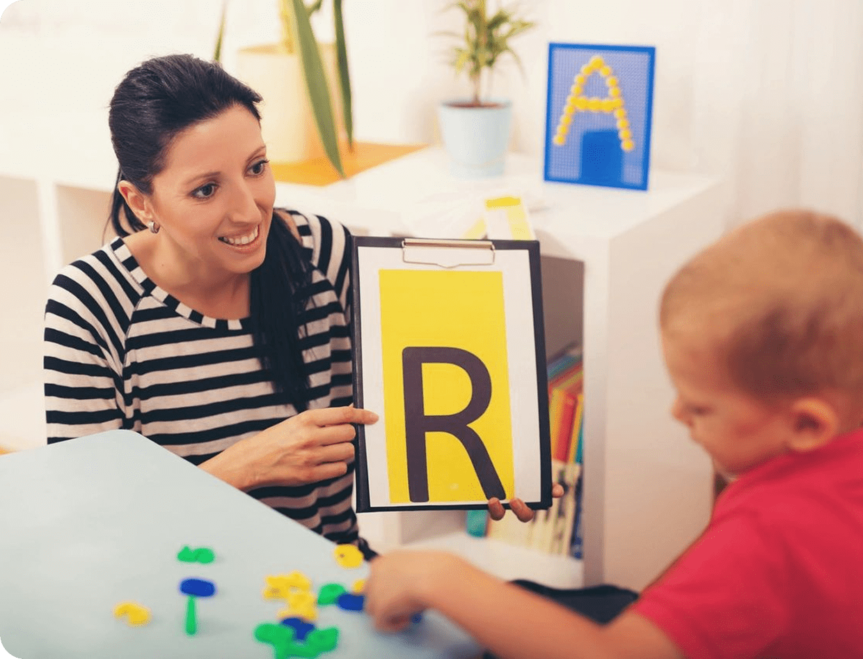 Educator teaching alphabet to young student