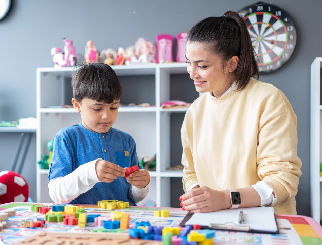 Boy playing with blocks in classroom setting