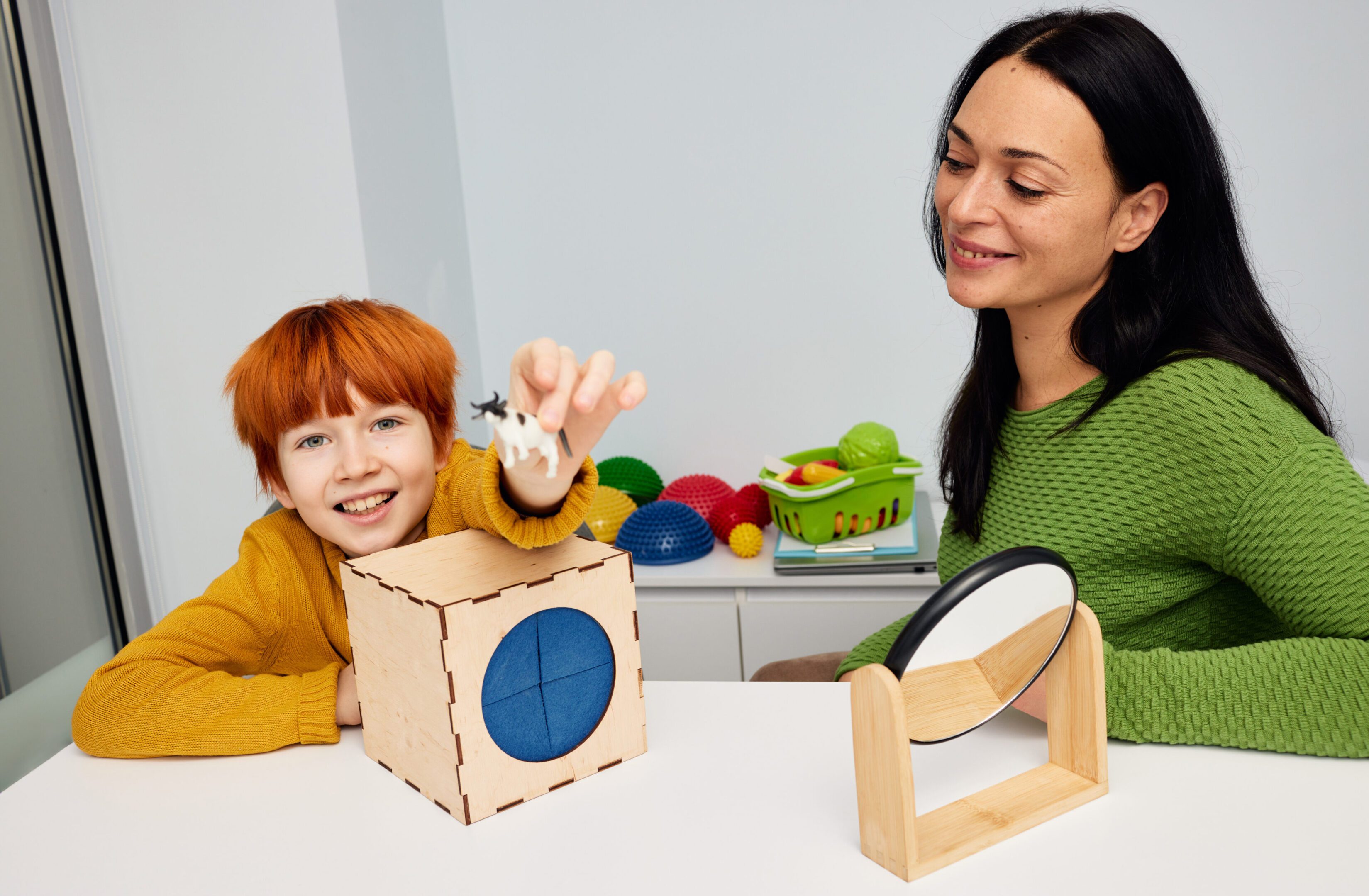 Woman watching child play with toys